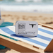 Beach Tallow Balm on beach chair under umbrella
