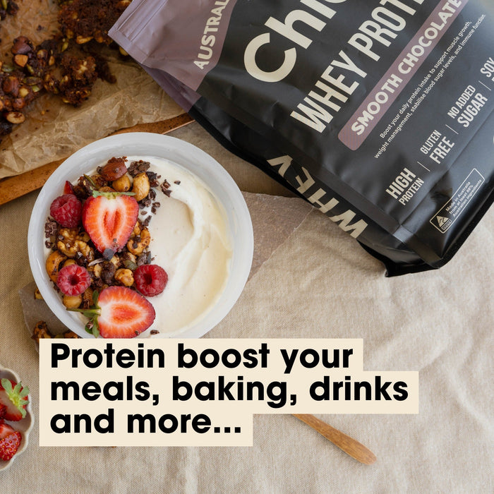 Grass-fed Whey Protein Powder - Smooth Chocolate - 900g by Chief next to yogurt bowl with berries and nuts for Keto and Low Carb diets