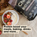Grass-fed Whey Protein Powder - Smooth Chocolate - 900g by Chief next to yogurt bowl with berries and nuts for Keto and Low Carb diets