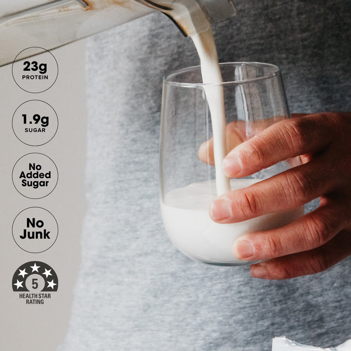 Person pouring creamy vanilla shake from Grass-fed Whey Protein Powder - Creamy Vanilla - 900g by Chief into glass
