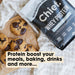 Grass-fed Whey Protein Powder - Creamy Vanilla - 900g by Chief beside freshly baked chocolate chip cookies on parchment paper