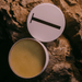 Open container of Holy Grail Tallow Balm - 70g by Tuttofare placed on natural stone surface in earthy setting