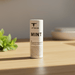 Mint Lip Balm on wooden bathroom counter with mint leaves