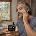 Man applying Bare Bones Beauty Sensitive Tallow Balm - 40ml on cheek for gentle skincare in bright bathroom setting